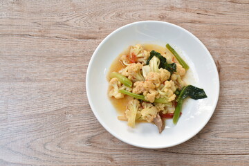 spicy stir fried cauliflower with carrot and pork on plate