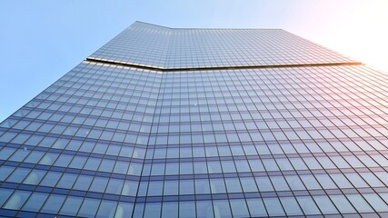 Concept for real estate and corporate construction..The modern office building of the orange morning sun in the sky background.