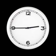 White round analog wall clock isolated on black background.