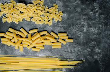 on black and white ground, auger pasta, pipe pasta, spaghetti, bow tie pasta