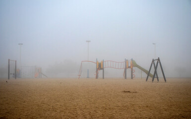 Playground on foggy morning in the park. Outdoors
