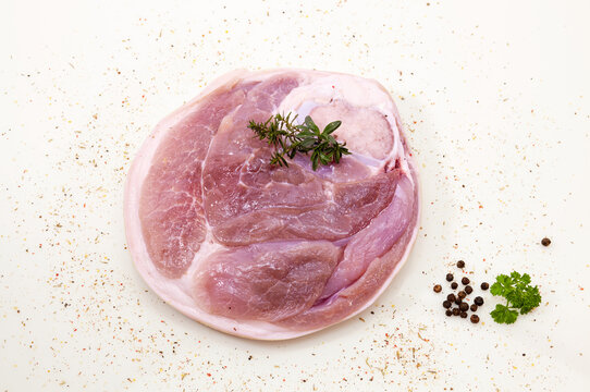 Beef Leg Slice salted with spice isolated on spicy background. Round beef steak, slice of leg, with a tender fat strip with skin, spiced with aromatic brine
