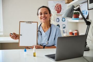 Medical woman indicating a place in a notebook with pen