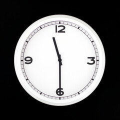 White round analog wall clock isolated on black background.