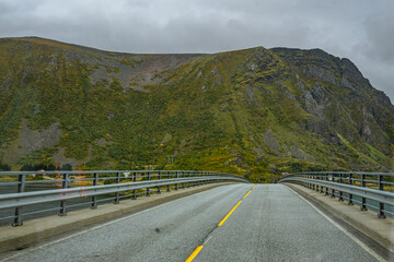 Street on lofoten islands with mountains in the background