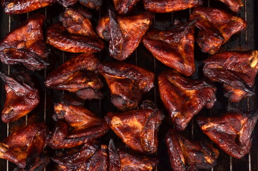 Grilled chicken wings on a baking sheet. Roasted in oven crispy sticky honey chicken wings, top view