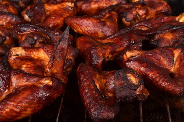 Grilled chicken wings on a baking sheet. Roasted in oven crispy sticky honey chicken wings, top view
