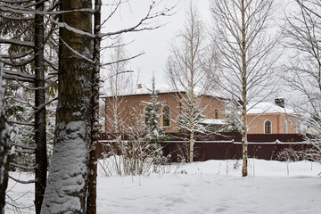 Fototapeta na wymiar House in winter forest full of snow