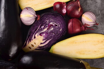 Still life of fresh purple vegetables on a gray background. Collection of fresh purple vegetables,...