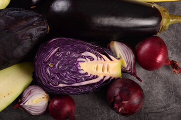 Still life of fresh purple vegetables on a gray background. Collection of fresh purple vegetables, Vegetable background