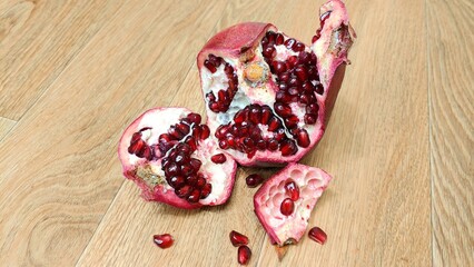 pomegranate seeds on wooden background