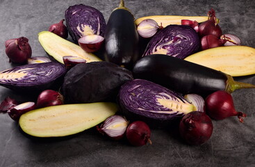 Still life of fresh purple vegetables on a gray background. Collection of fresh purple vegetables, Vegetable background