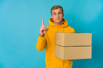 Young caucasian man doing moving over isolated background