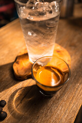 Espresso coffee is flowing into the shot cup.