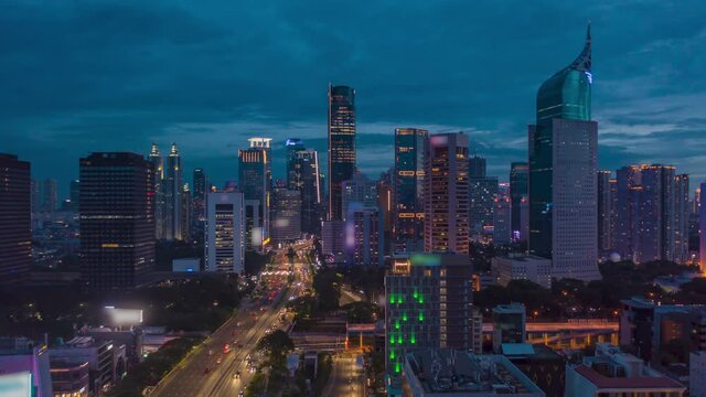 Aerial dolly hyperlapse shot of busy night time traffic on multi lane highway through modern city center with skyscrapers in Jakarta, Motion Time Lapse Hyper Lapse - Powered by Adobe