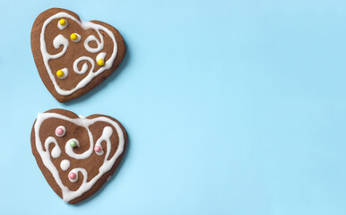 Two gingerbread cookies on a blue background, dessert as a gift, copy space for text