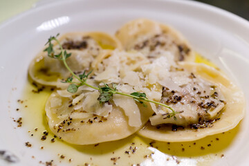 Cheese Ravioli with Cream Sauce, Black Pepper and Rosemary. Soft focus image.