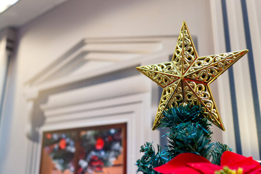 Shining Christmas star decorated on Christmas tree closeup. Selective focus image.