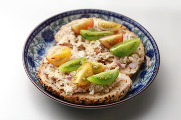 Baby tomatoes tuna mayonnaise mixed salad on toasted brown sandwich bread