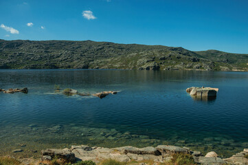 Fresh water at the Long Lake on highlands covered by bushes and rocks, at the Serra da Estrela. The highest mountain range in continental Portugal.