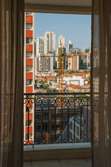 Fototapeta na wymiar City skyline seen from a balcony in a building in São Paulo. The gigantic city, famous for its cultural and business vocation in Brazil.