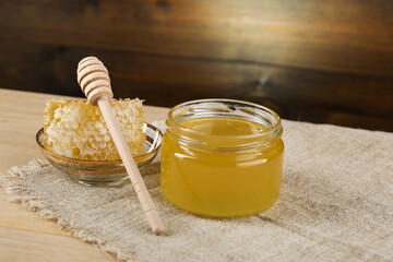 fresh honey is on a wooden background