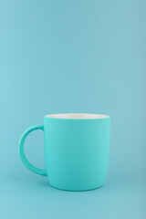 empty turquoise mug on turquoise background