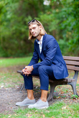 Portrait of young handsome stylish man. Outdoor fashion portrait.