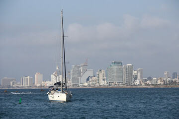 the yacht enters the harbor bay of Old Jaffa with a view of Tel Aviv in the background