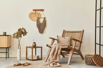 Fotobehang Boho Stylish interior design of living room with wooden armchair, coffee table, furniture, rattan decoration, dried flowers and elegant personal accessories. Copy space white wall. Template.  © FollowTheFlow