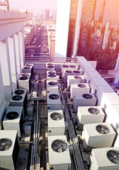 many air conditioners on the roof of the building