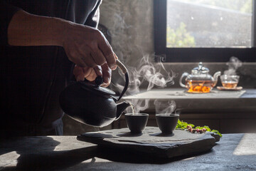 Cup of hot Flowering tea dry tea leaves ,Hot tea in glass cup with steam .hot food and healthy meal concept