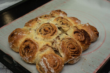 Beautiful fresh cinnamon rolls. The cooking process. Fresh fragrant pastries. Raw dough for buns.The process of making buns sinabon.