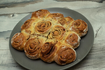 Beautiful fresh cinnamon rolls. The cooking process. Fresh fragrant pastries. Raw dough for buns.The process of making buns sinabon.