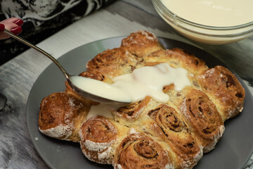 Beautiful fresh cinnamon rolls. The cooking process. Fresh fragrant pastries. Raw dough for buns.The process of making buns sinabon.
