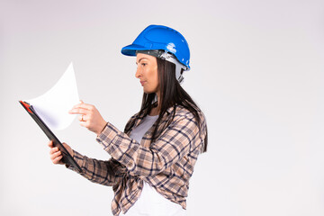 A female engineer examines documents on a white background with blank side space.