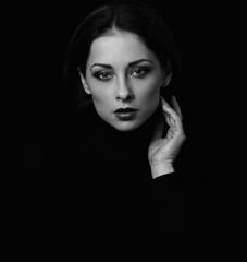 Sexy angrywoman with bright evening makeup  posing isolated on dark black background. Closeup...