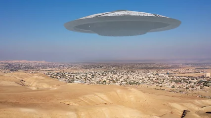 Fotobehang Alien Spaceship ufo Flying over city in the desert - aerial view , drone view over Jericho city in Palestine with visual effect element, invasion sci fi concept  © ImageBank4U