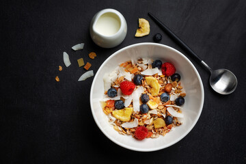 Muesli with berries and fruits in bowl