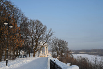 The embankment of Kirov in Russia on a sunny frosty winter day. White Rotunda in the Alexander...