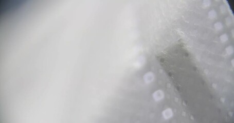 Super close macro shot showing details of an FFP2 face mask, which is mandatory to wear in public places in many countries in Europe and all around the world during the COVID-19 pandemic.