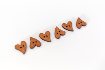 Close-up small wooden hearts on white background. Valentines day.