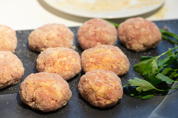 Cooking meat cutlets. Semi-finished meatballs on a cutting board.