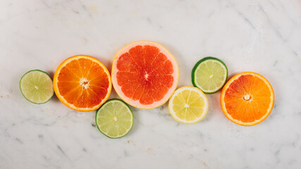 Colorful fruit background top view. slices of red orange, lime, lemon, grapefruit are on white background. Fresh citrus fruit rich of vitamins, juicy fruit, healthy nutrition. Orange color