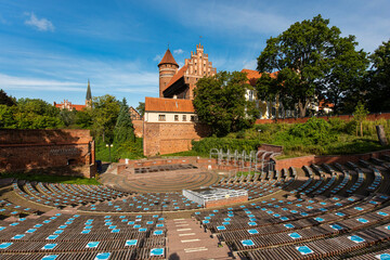 A historic gothic brick castle with an amphitheater and a tower in Olsztyn, Warmia, Poska
