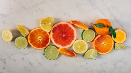 Colorful fruit background top view. slices of red orange, lime, lemon, grapefruit are on white background. Fresh citrus fruit rich of vitamins, juicy fruit, healthy nutrition.