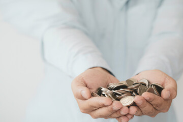 Businessman holding coins in hand , investment profit and dividend money from saving concept.