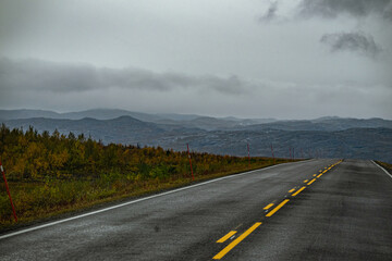 Lonely road with grey clouds in north Norway