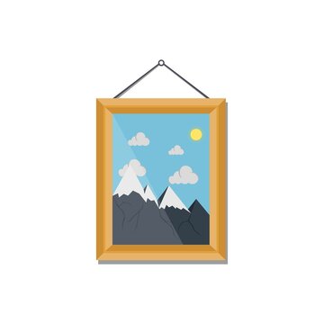 Picture in wooden frame with mountains hanging on the wall. Template for different images. Design element for interior. Picture frame with natural landscape.