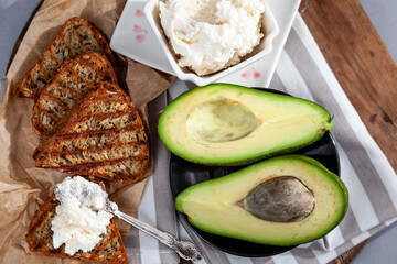 Sandwiches with soft cheese, avocado and cucumber. Breakfast is on the table. Healthy food. Toast and spread on it. Avocado sandwich stilllife. Healthy food. Toast.